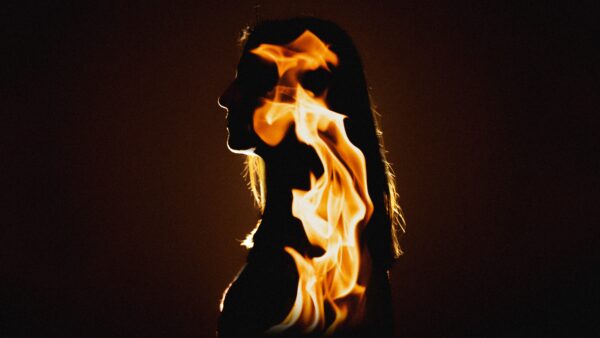 Silhouette of Emma Johnson with flames