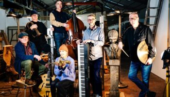 six musicians in wood workshop
