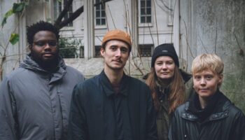 four musicians posed outdoors