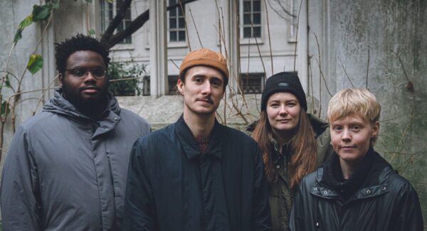 four musicians posed outdoors