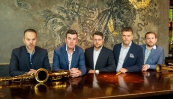 five musicians sitting at table