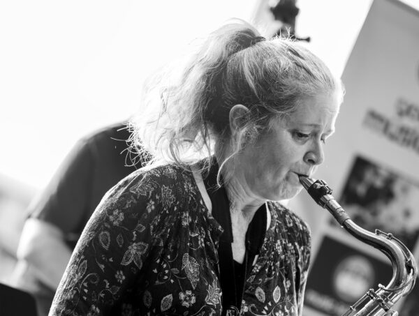 monochrome image of Sue Ferris playing saxophone
