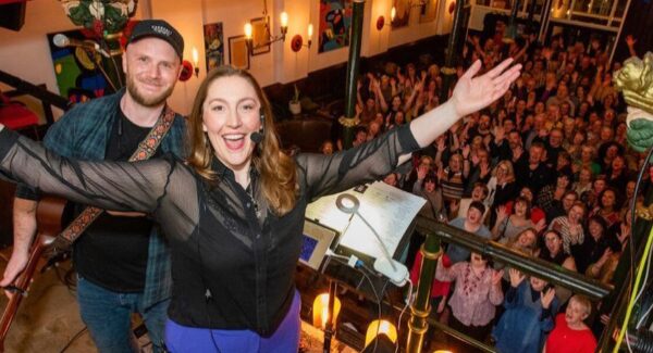 Abi Moore and a crowd of singers
