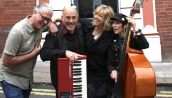 four musicians pictured in the street