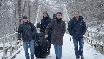 four musicians walking in the snow