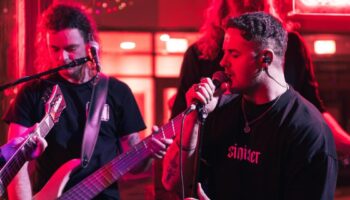 three musicians playing in club